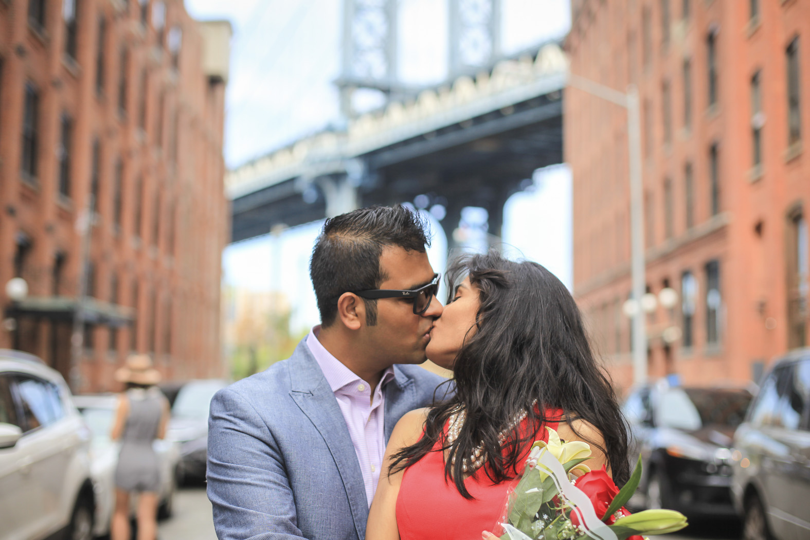 Mukul and Asha kissing after their proposal, a bridge behind them